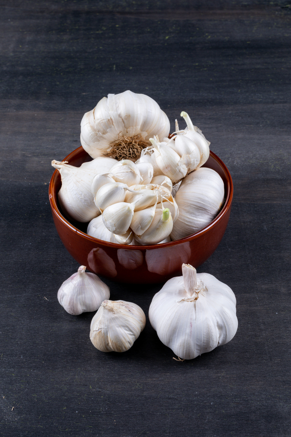 bunches-garlic-bowl-dark-wooden-table